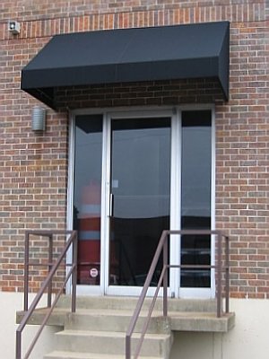 The crisp lines of this awning really dress up this commercial entrance and soften the brick exterior